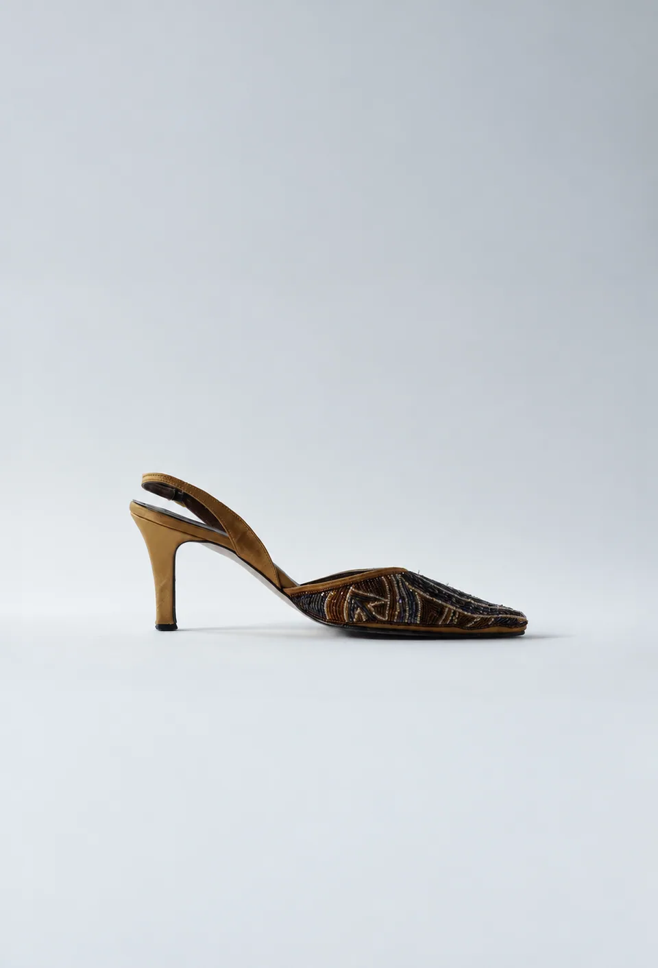 Bronze and gold beaded pointed-toe slingback heel with a golden heel, side profile.
