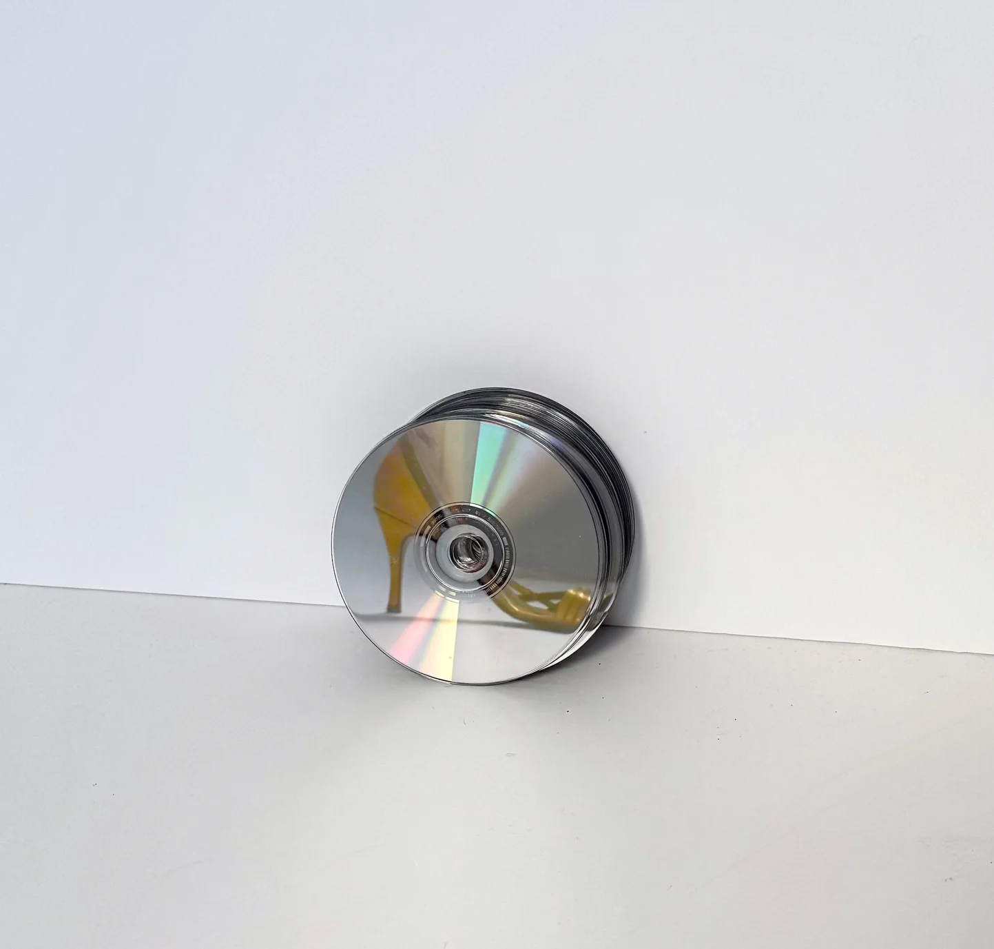 A compact disc reflecting a gold vintage heel