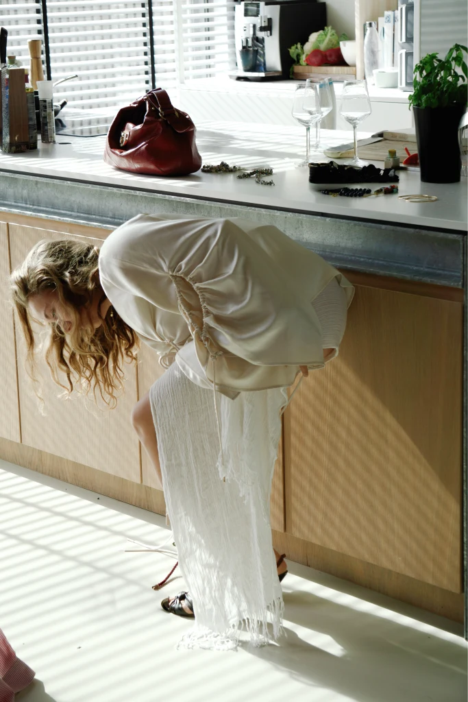 A pale blouse and skirt styled with vintage sandals